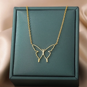 Minimalist hollow butterfly pendant necklace in gold stainless steel on green jewelry box