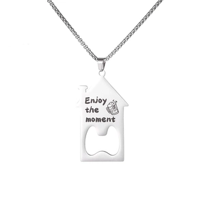 Macro detail of house-shaped stainless steel bottle opener necklace with engraved text