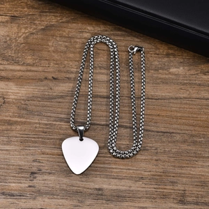 Minimalist silver stainless steel guitar pick necklace with box chain on wood surface