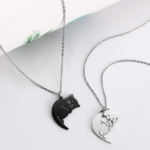 Minimalist black and silver cat couple necklaces in polished stainless steel