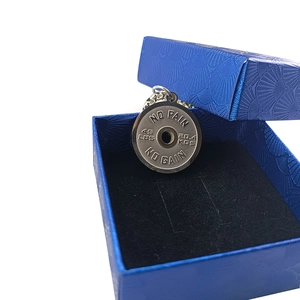 Detailed close-up of barbell weight plate pendant with No Pain No Gain motivational text