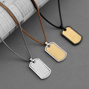 Three stainless steel dog tag necklaces in silver, gold, and black with box chains