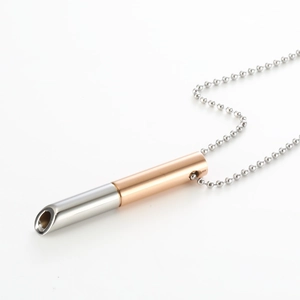 Detailed macro of two-tone silver and rose gold mindfulness breathing pendant necklace