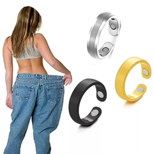 Detail of adjustable C-shaped magnetic therapy rings in silver, black and gold finishes