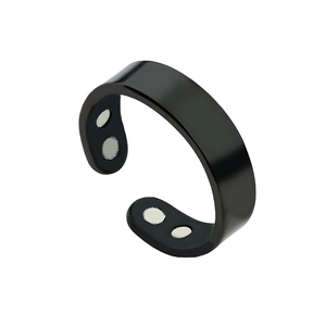 Polished black magnetic therapy open ring with four silver magnets on white background