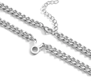 Detailed close-up of Taurus zodiac pendant on a silver stainless steel Cuban chain necklace