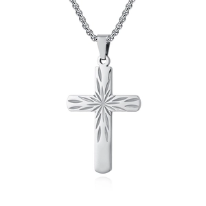 Detail of silver cross pendant with sunray engraving and polished stainless steel box chain