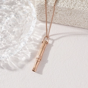 Mindfulness breathing whistle necklace in rose gold finish on elegant white display