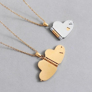 Polished gold and silver heart locket necklaces with a small cutout heart detail