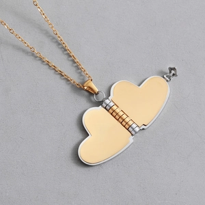 Polished gold stainless steel heart locket necklace with an openable book design