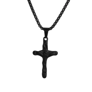 Detail of black gothic cross necklace with organic texture on stainless steel pendant