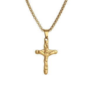 Macro detail of gold cross pendant with lava texture and Jesus relief on box chain