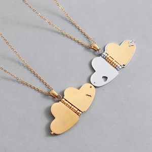 Macro view of three-layer foldable heart locket pendant in gold and silver finish