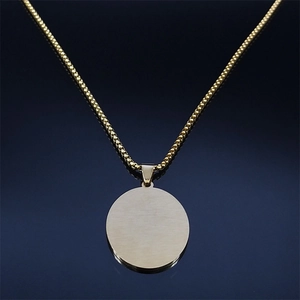 Detailed macro shot of a round gold pendant with box chain on a dark gradient background