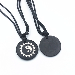 Yin Yang Bagua ox bone pendant necklace with sun and Tai Chi patterns on black cord