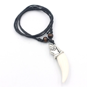Punk shark tooth necklace with resin pendant and black wax cord on a white background