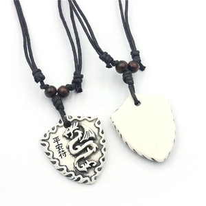 Shield dragon pendant necklace with white resin carving and adjustable black woven cord