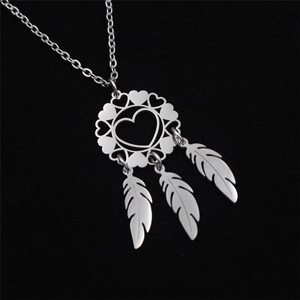 Detailed close-up of stainless steel dreamcatcher pendant with heart and feathers