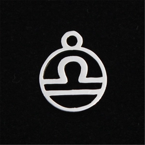 Macro shot of silver Libra constellation pendant in stainless steel with hollow design
