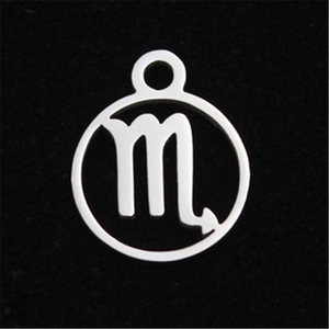 Macro shot of Scorpio zodiac pendant in polished stainless steel on black velvet