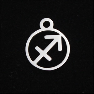 Macro shot of silver stainless steel Sagittarius zodiac charm with hollow cut design