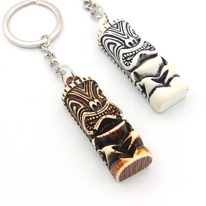 Tribal Tiki totem resin keychains in bone white and wood brown with metal rings