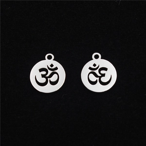 Set of two polished stainless steel hollow Om symbol round pendant charms on black background