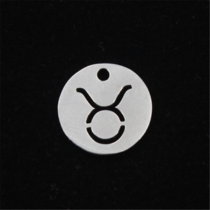 Macro shot of polished stainless steel Taurus zodiac pendant with hollow out design