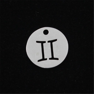 Macro detail of silver stainless steel Gemini zodiac sign pendant with hollow design