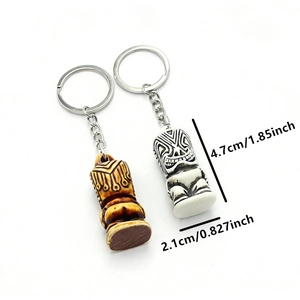 Detailed size view of Tiki statue keychains with resin bone and wood texture