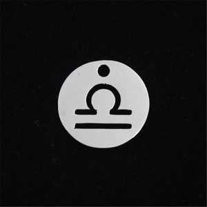 Detailed close-up of a silver stainless steel Libra zodiac pendant with hollowed-out design