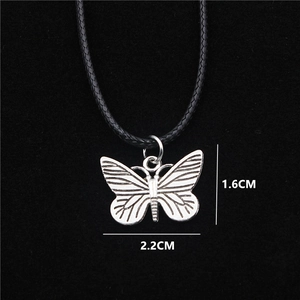 Silver butterfly pendant necklace with black woven cord and detailed wing texture