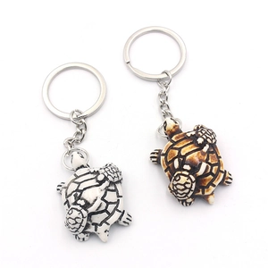 Detail view of brown and white turtle keychains with mother-and-child design in resin