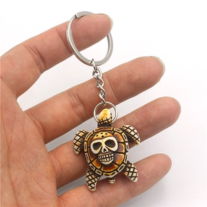 Halloween turtle keychain with skull pattern made of resin and vintage brown finish