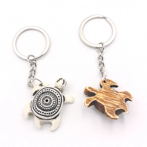 Resin sea turtle keychains with spiral patterns and natural bone texture on white background