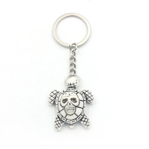 Halloween turtle keychain with skull pattern on resin shell and silver metal ring