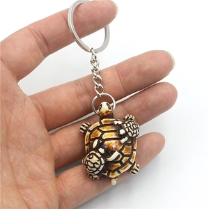 Resin sea turtle keychain with baby turtles on back and vintage brown finish