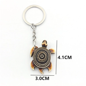 Tribal style turtle keychain with swirl pattern resin shell and silver metal ring