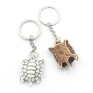 Turtle keychain set in white and brown resin with detailed shell texture on white background