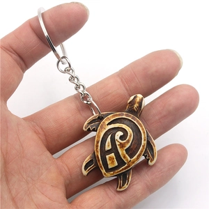 Tribal turtle keychain featuring cream and brown bone resin textures on a metal ring