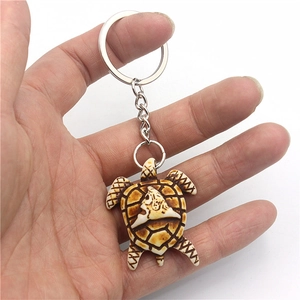 Handheld turtle keychain featuring detailed resin sea turtle pendant with silver metal ring