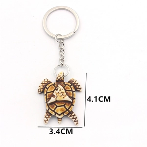 Brown resin turtle keychain with antique carved texture measuring 4.1cm by 3.4cm