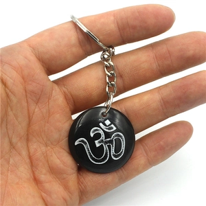 Resin Om symbol keychain with a black circular pendant and silver metal keyring