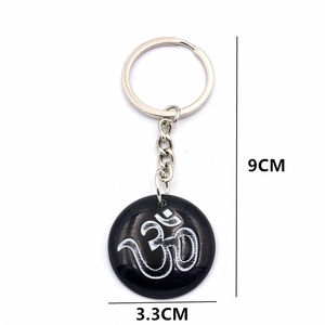 Resin Om symbol keychain with silver pendant design, 9cm length and 3.3cm diameter