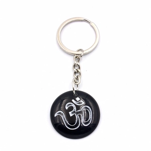 Spiritual Om symbol resin keychain with polished black round pendant and silver ring