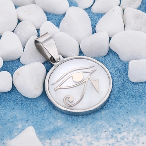 Polished stainless steel Eye of Horus shell pendant necklace on blue sand and pebbles