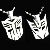 Detail view of silver stainless steel Transformers Autobot and Decepticon pendant necklaces