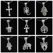 Detail view of 9 vintage stainless steel pendants featuring tree of life and animal symbols
