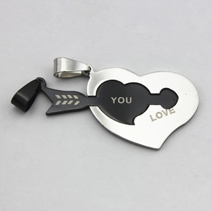 Detail of interlocking stainless steel heart and arrow pendant with LOVE YOU engraving