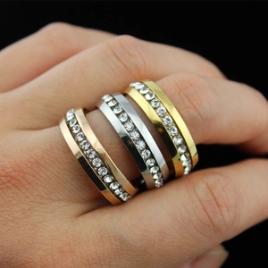 Detailed view of three stackable rings in rose gold, silver, and gold with pave crystals
